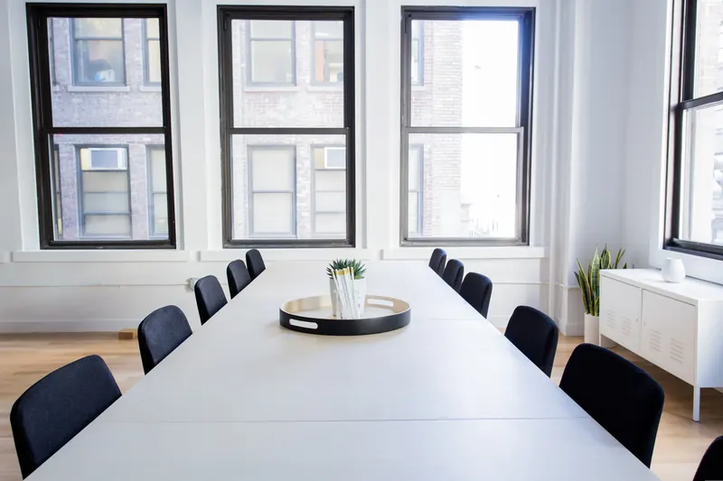 An empty boardroom with a long table