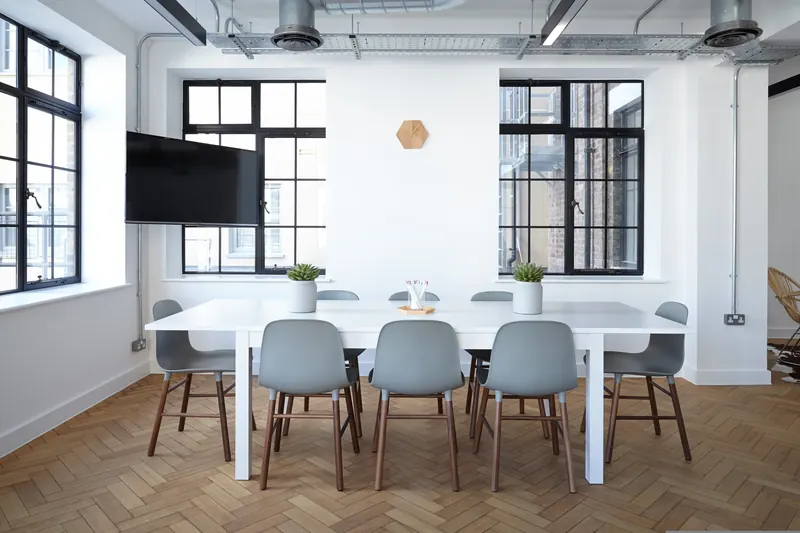 An empty meeting room with a square table